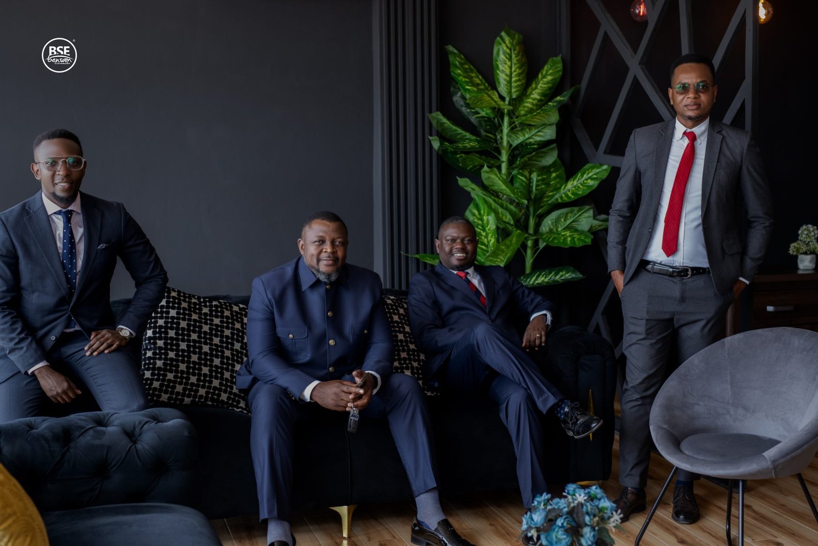 Four executives in a dark lounge