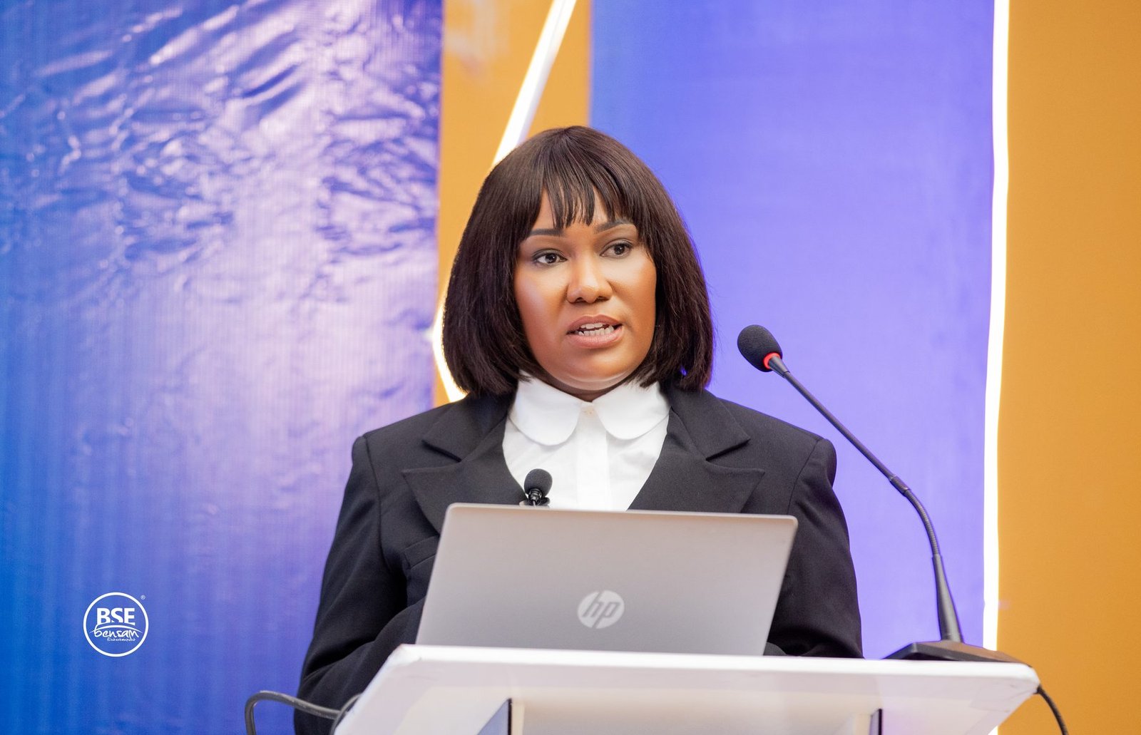 Speaker at a lectern addressing a conference